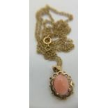 A coral pendant on a 9ct yellow gold chain, 46cms l. Total weight 2.1gms.