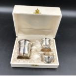 A French silver plated christening set to include a napkin ring, egg cup and beaker 7cms h. All in