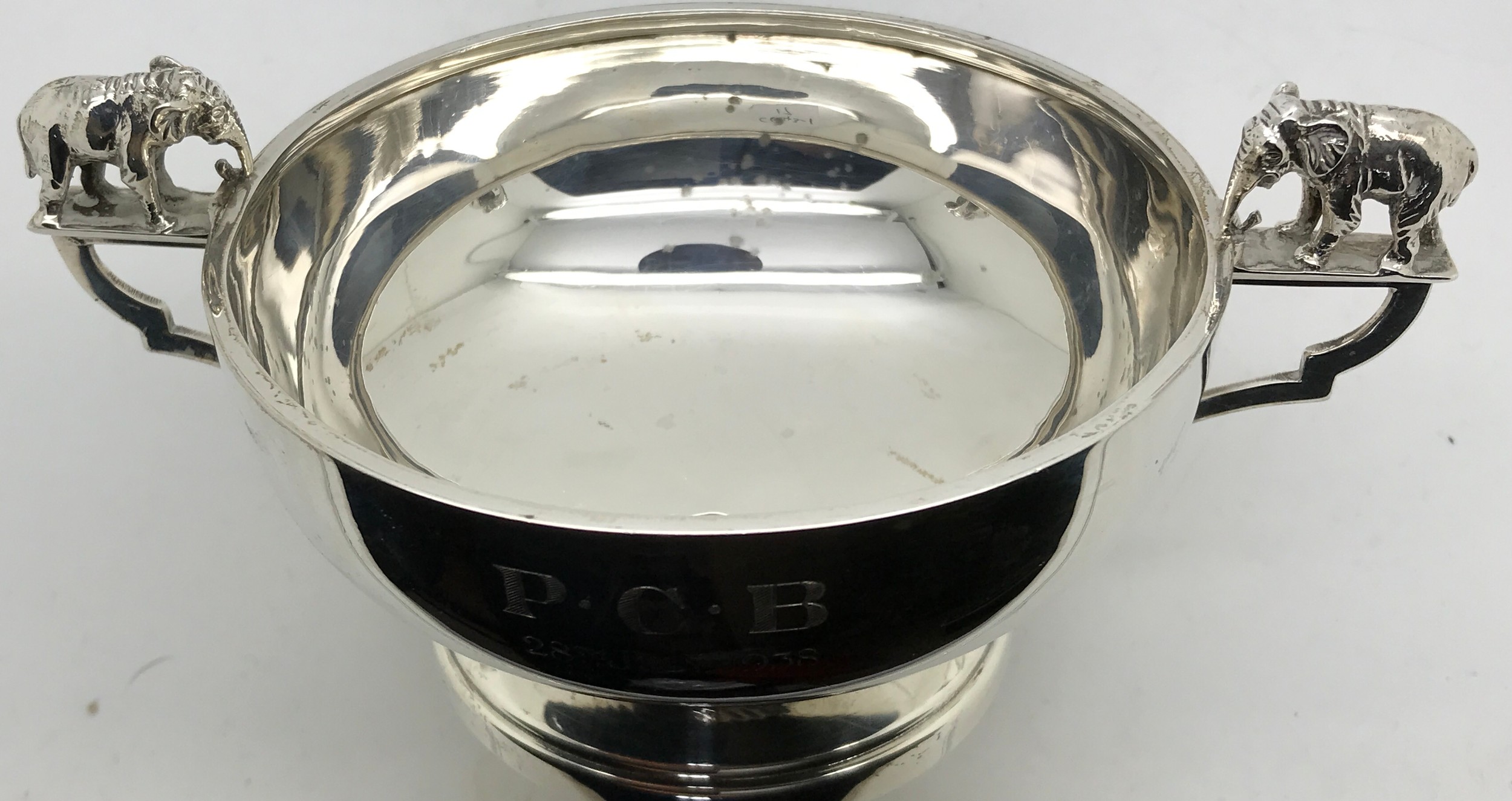A silver two handled dish with elephant to handles and engraving 'P.C.B 28th July 1938'.