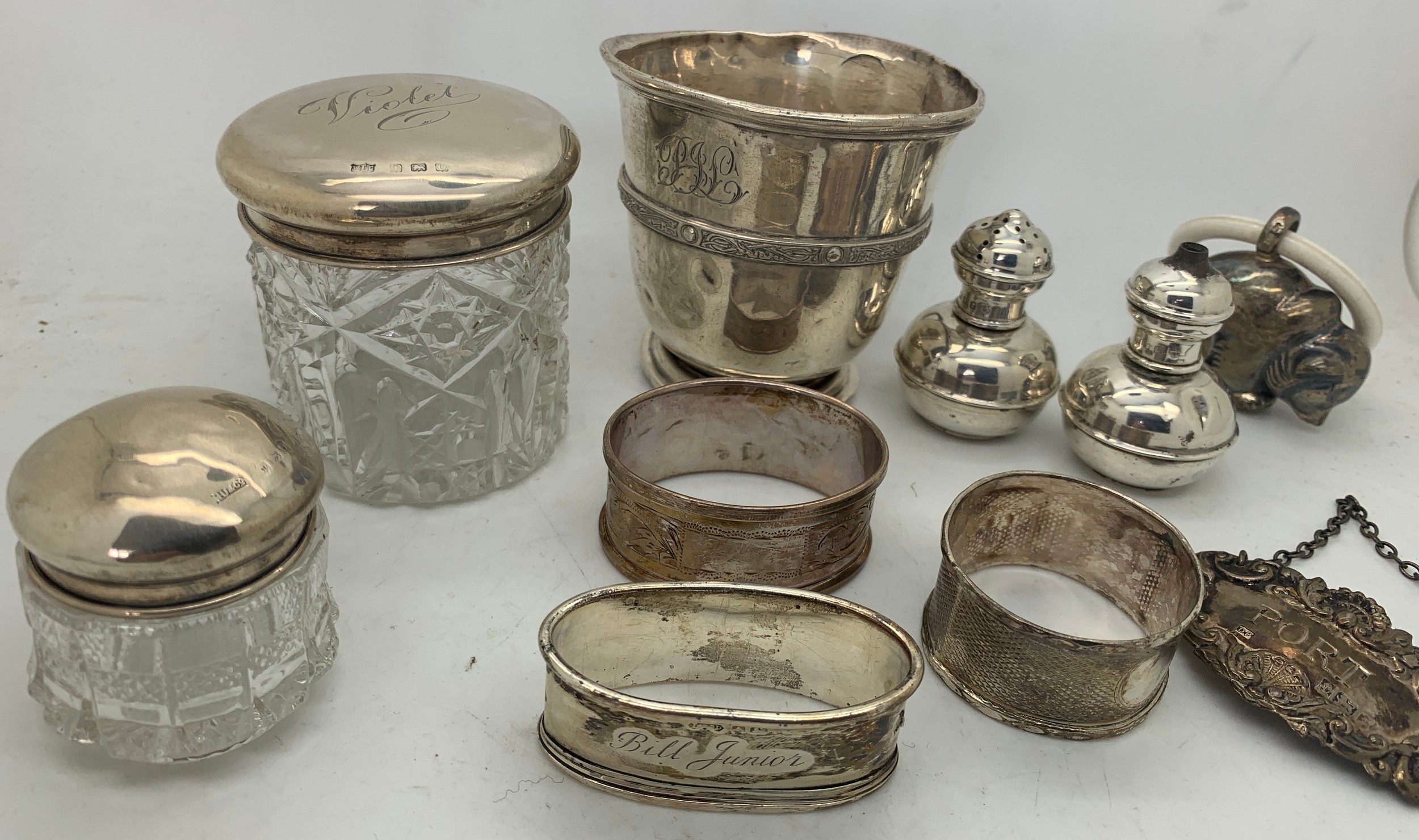 Hallmarked silver items and a child's rattle marked .800 to include napkin rings, Port label, mug - Image 2 of 3