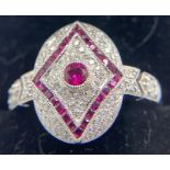 An 18ct white gold ring set with diamonds and rubies in an Art Deco style. Size O. Weight 4.1gms.