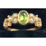 A peridot and seed pearl ring set in 9ct yellow gold. Size N. Weight 2.4gms.Condition ReportSlight