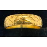 A 22ct gold band decorated with flowers and leaves. Size N, weight 5.4gms.Condition ReportGood