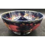 Moorcroft bowl, pomegranate pattern, blue ground 20.5cms w x 9.5cms h with impressed marks to base.