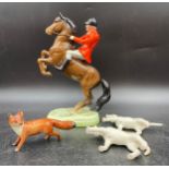 A Beswick figure of a huntsman on a rearing horse 25cms h together with a Beswick fox 6cms h and 2