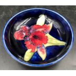 A Moorcroft circular dish 11.5cms w x 4cms h, impressed mark to base.Condition ReportGlaze crackle