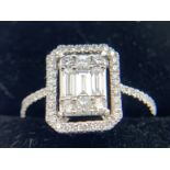 An 18ct white gold ring set with 3 baguette cut diamonds to centre. Size O. 3.8gms.Condition