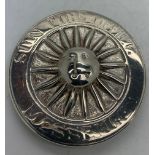 A silver Sun Fire Office fireman's badge, the circular badge with central sun motif, the border