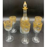 A decanter and five wine glasses with gilt decoration in the manner of James Giles. Decanter of