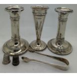 Hallmarked silver to include a pair of candlesticks with weighted bases, vase, sugar tongs, 2