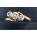 A 9ct and platinum ring set with three diamond, size I, weight 2gms.