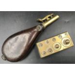 A leather and brass gunpowder flask 20cms l and a part set of brass weights 2gms to 100gms.Condition