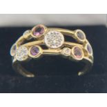 A yellow metal gem set ring marked .375. Size V/W. Weight 3gms.Condition ReportGood condition.