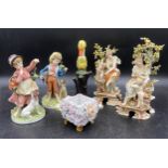 A selection of Continental ceramics to include two pairs of figurines one of ladies with cherubs