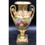 A 19thC gilt and floral painted vase, rams head handles. 33 h x 18cms w at handles.Condition