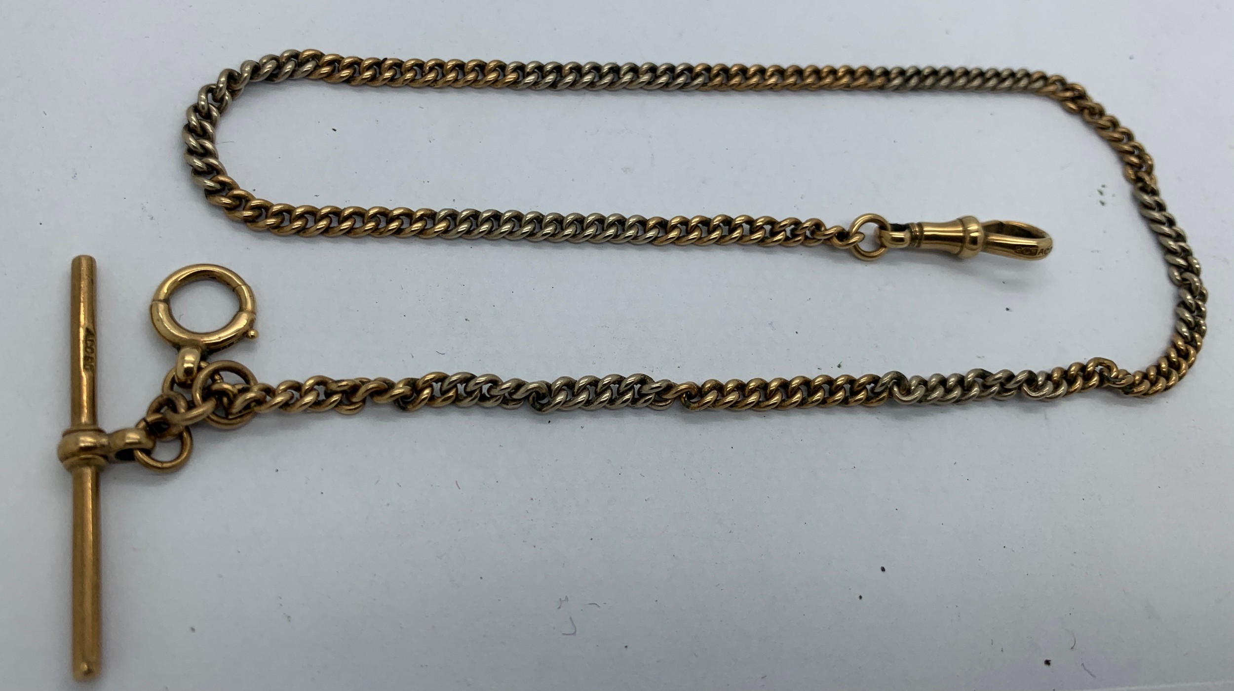 A 9ct white and yellow gold chain with T bar. 12.8gms total weight. 35cms l.Condition ReportGood