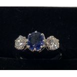 A PLATINUM SAPPHIRE & DIAMOND THREE STONE RING, central Sapphire weight 1.00ct, flanked by a diamond