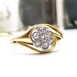 AN 18CT YELLOW GOLD ANTIQUE OLD MIND CUT DIAMOND RING, with a central floral shaped mount, having