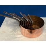 A SET OF 7 GOOD QUALITY COPPER SAUCEPANS with iron handles