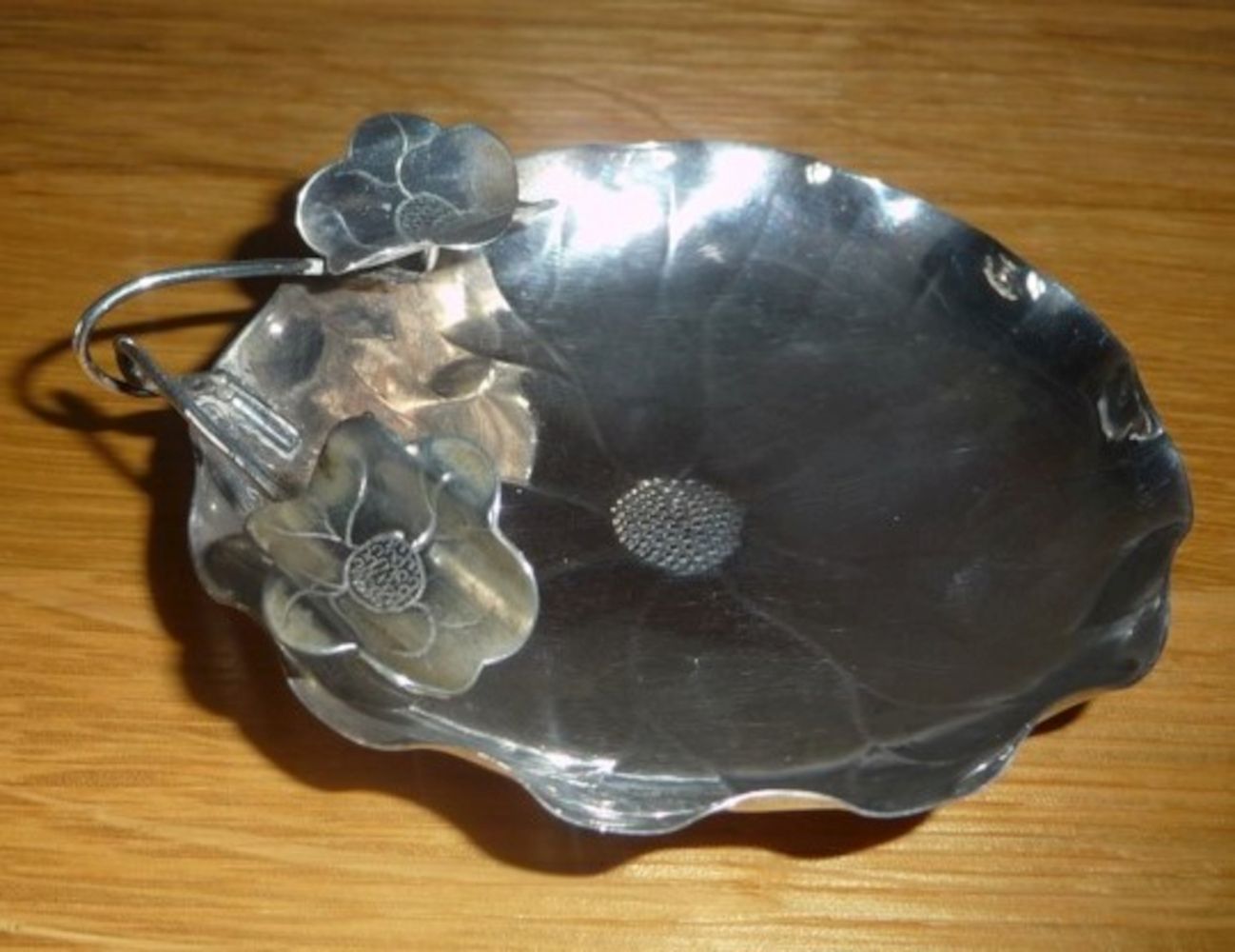 AN EARLY 20TH CENTURY CHINESE SILVER DISH IN THE FORM OF AN OPEN FLOWER, with two smaller flowers