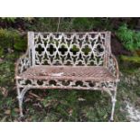 A REGENCY CAST IRON GARDEN SEAT, in gothic style, 40 inches wide x 34 inches tall x 20 inches deep