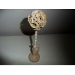 A CHINESE IVORY PUZZLE BALL on a stand, the ball with six inner balls, all hand carved, circa 1890-