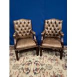 A PAIR OF MAHOGANY FRAMED BUTTON BACKED LEATHER ARM CHAIRS, with beaded details, raised on square