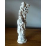 A JAPANESE IVORY OKIMONO OF AN ELDERY MAN & BOY MUSICIANS, the younger stands upon the elder, both