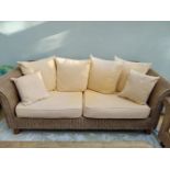 A LARGE THREE SEATER WICKER COUCH, 6ft wide approx