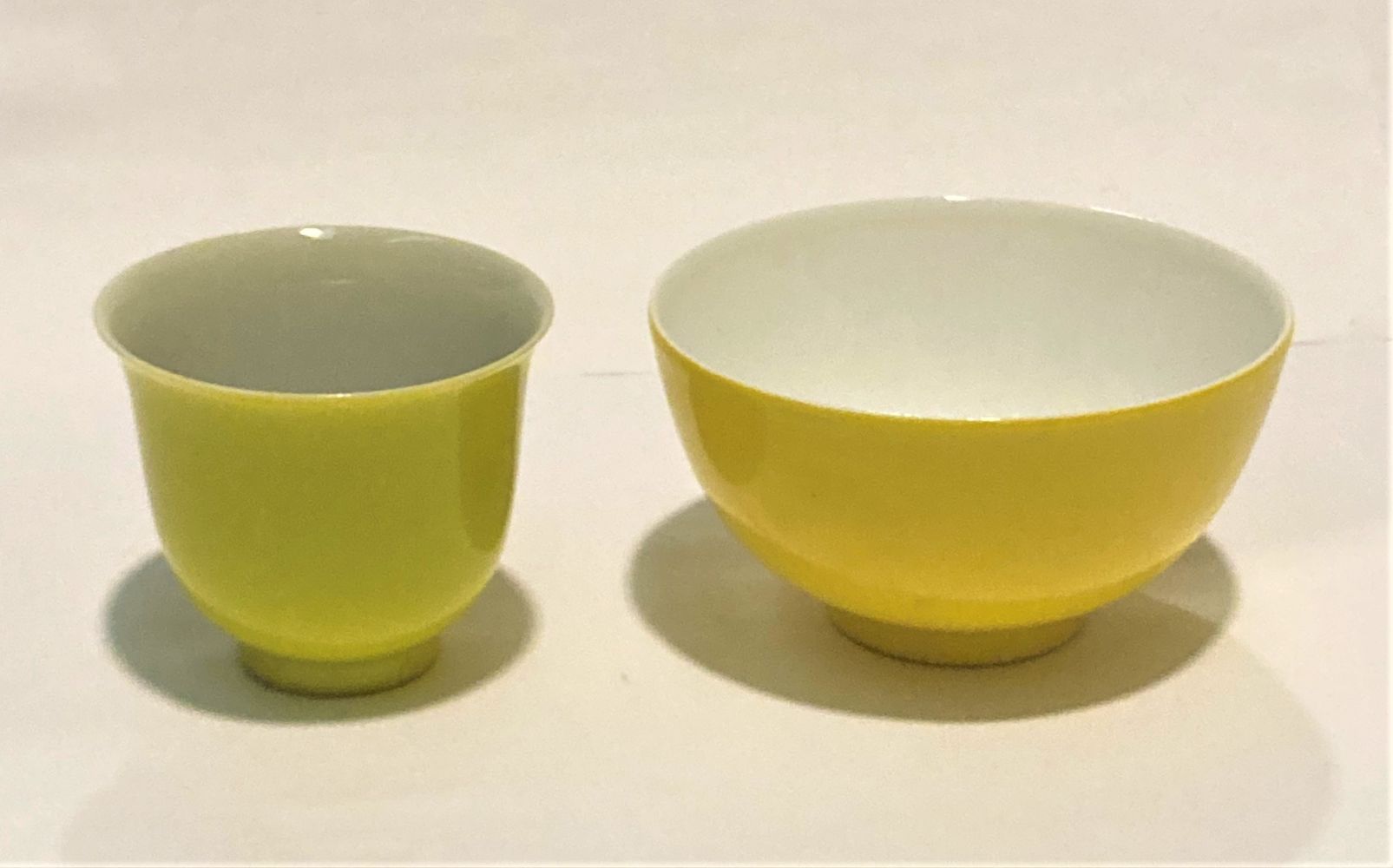 A CHINESE PORCELAIN YELLOW GLAZED TEA BOWL AND SAUCER, both with six character to base, saucer