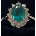 AN EXQUISITE 18CT WHITE GOLD COLUMBIAN EMERALD & DIAMOND CLUSTER RING, Emerald weight 3.50cts,