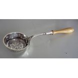 AN EARLY 20TH CENTURY DUTCH SILVER SIFTING/CASTOR SPOON, the deep bowl decorated all over with