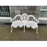 A WHITE CAST IRON GARDEN BENCH