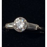 A 14CT WHITE GOLD DIAMOND SOLITAIRE RING, with tapered baguette shoulders, total diamond weight 1.