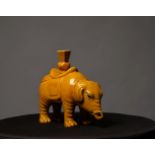 A 20TH CENTURY CHINESE POTTERY ELEPHANT, c.1900, with yellow glaze, 9in long x 7 ¾in