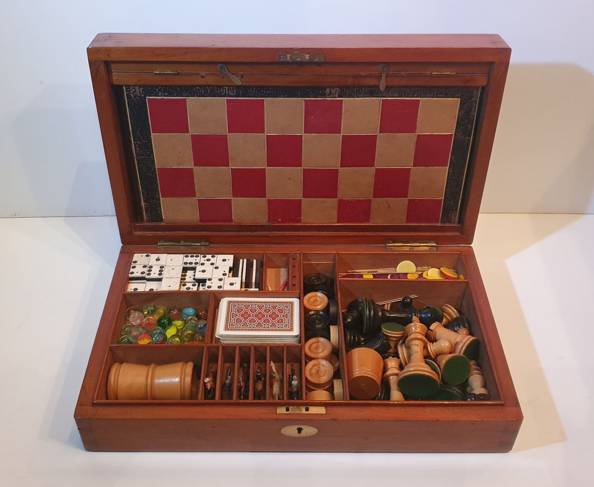 A RARE 19TH CENTURY MAHOGANY GAMES BOX, including contents, with chess, draughts, 3 board games