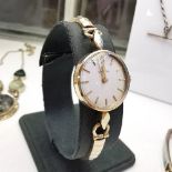 A 9CT GOLD OMEGA WRIST WATCH / LADIES WATCH, with manual wind up, case and strap are all solid 9ct