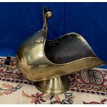 A GOOD VICTORIAN BRASS HELMET SHAPED COAL SCUTTLE, with conical base and black turned handle to