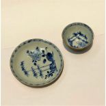 A NANKING CARGO TEA BOWL AND SAUCER, the interiors painted in blue with bamboo, peonies and rocks,
