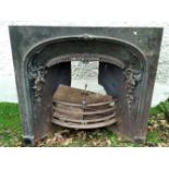 A 19TH CENTURY CAST IRON FIRE INSERT/SURROUND, with curved top with vine motif .40 inches wide x