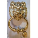 A RESTORED 19TH CENTURY BRASS DOOR KNOCKER, in the form of a lion head, with striker, 21.5cm (H) x