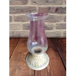 A CANDLE HOLDER, with glass chimney, 2 ft tall approx.