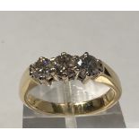 A 9CT YELLOW GOLD THREE STONE DIAMOND RING, .50 ct, ring size N