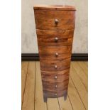 A 20TH CENTURY BOW FRONTED HARD WOOD 7 DRAWER CHEST,56 inches tal