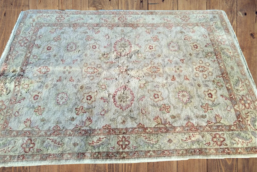 A WOOL FLOOR RUG, with floral design, 49 inches wide x 66 inches