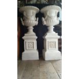 A GOOD PAIR OF COUNTRY HOUSE CAST IRON GARDEN URNS, on stands, th