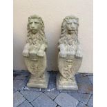 A PAIR OF STONE LIONS WITH SHIELDS, 81cm tall x 25cm x 25cm (base