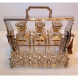 AN EDWARDIAN SILVER PLATED TANTULAS, with 3 decanters, and 12 gla
