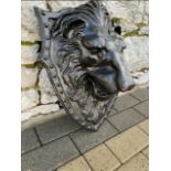 A CAST IRON GARDEN ORNAMENT OF A LIONS HEAD, wall mountable, 18 i