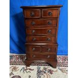 A MINIATURE SIZED 8 DRAWER MAHOGANY CHEST ON CHEST, with cock bea